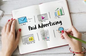 A hand drawing examples of paid media advertising on a notebook.